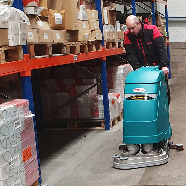 E61 scrubber dryer cleaning a concrete floor in warehouse